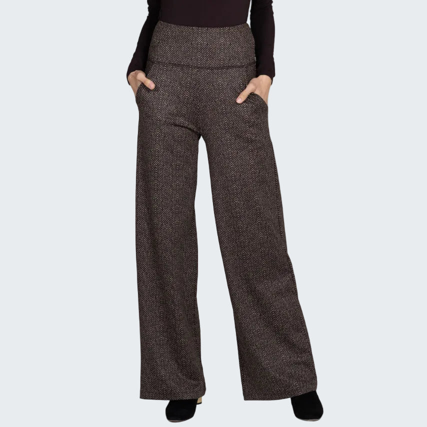 Brown patterned pants worn by a person on a gray background