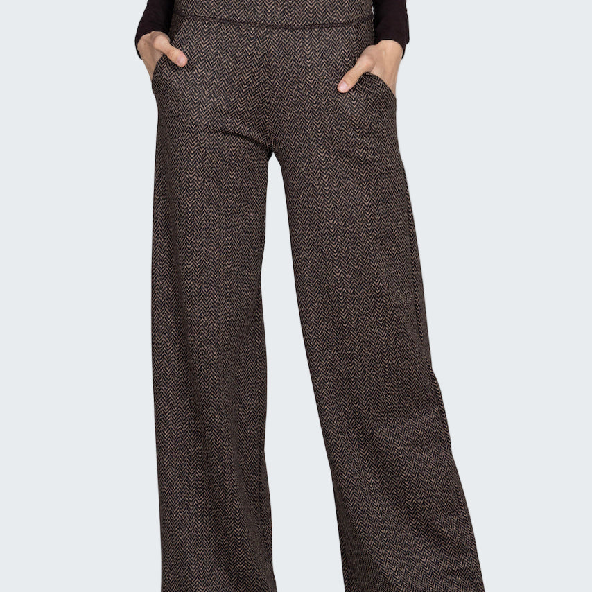 Brown patterned pants worn by a person on a gray background