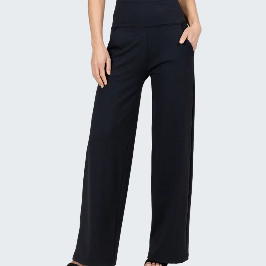 Black wide-leg pants worn by a person on a plain background