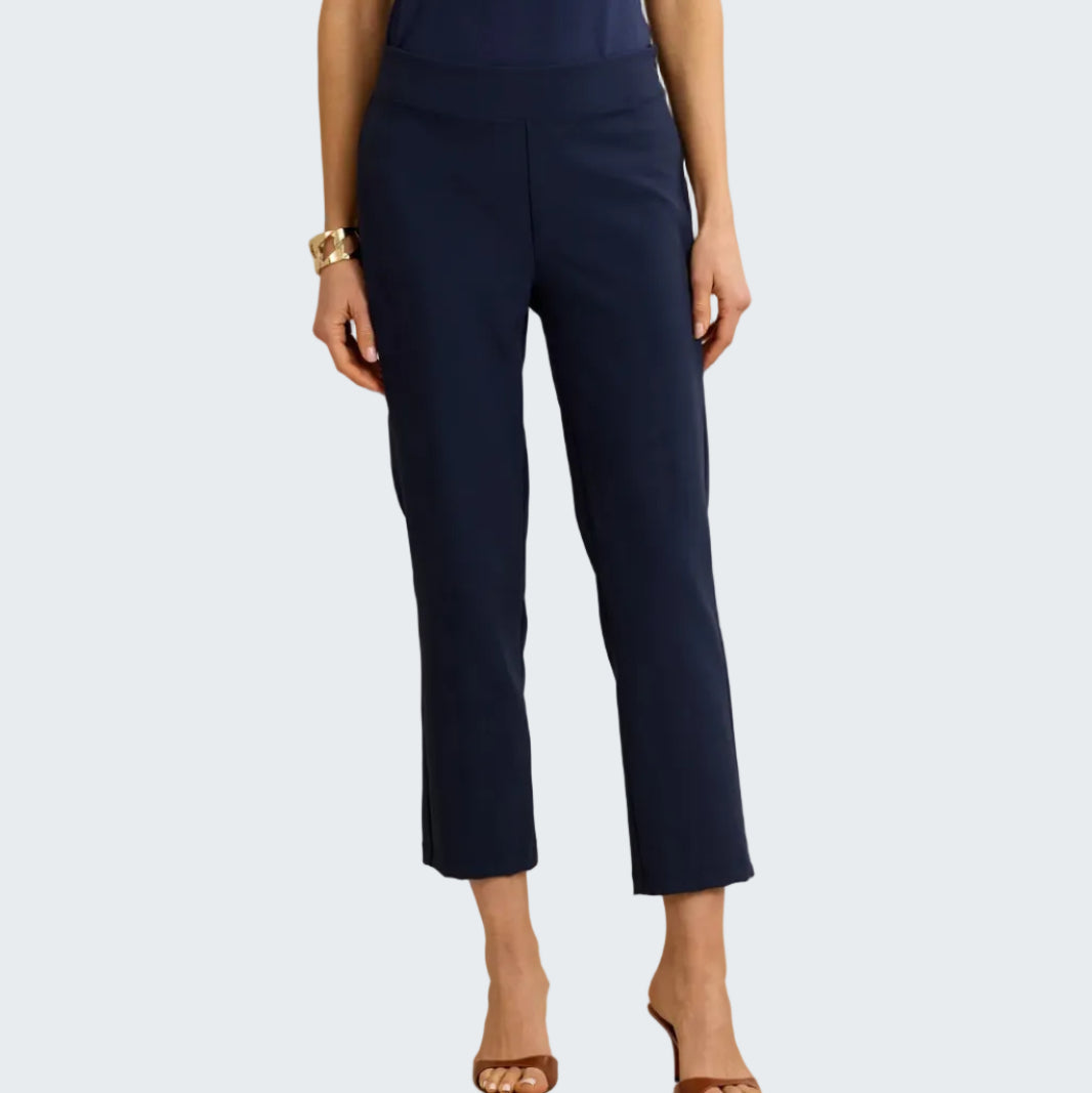 Navy blue pants worn by a person on a beige background