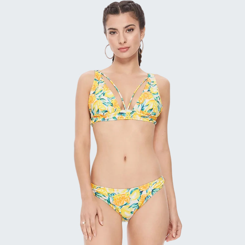 Woman wearing a yellow floral bikini on a white background