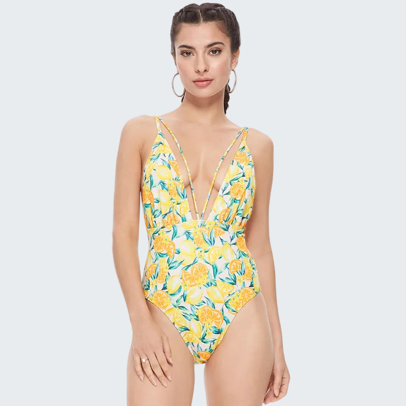 Woman wearing a yellow floral one-piece swimsuit on a white background