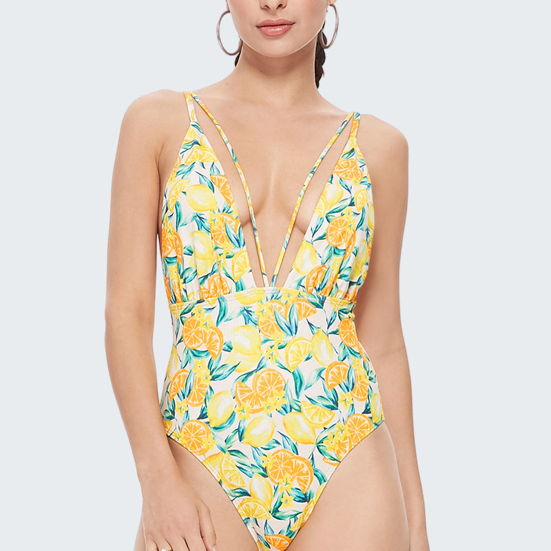 Woman wearing a yellow floral one-piece swimsuit on a white background