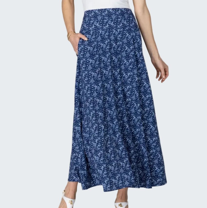 Woman wearing a blue floral skirt on a beige background