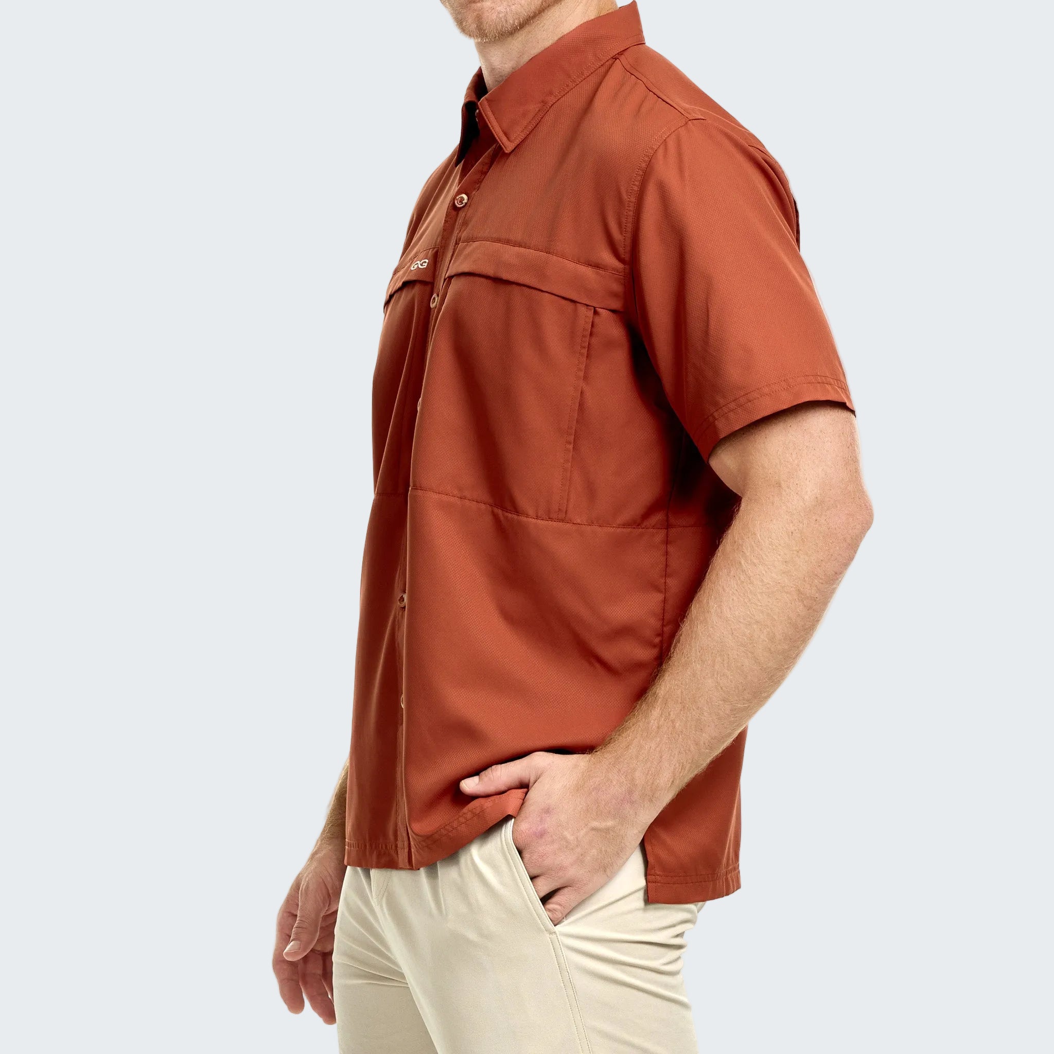 Man wearing a rust-colored short-sleeve shirt on a white background