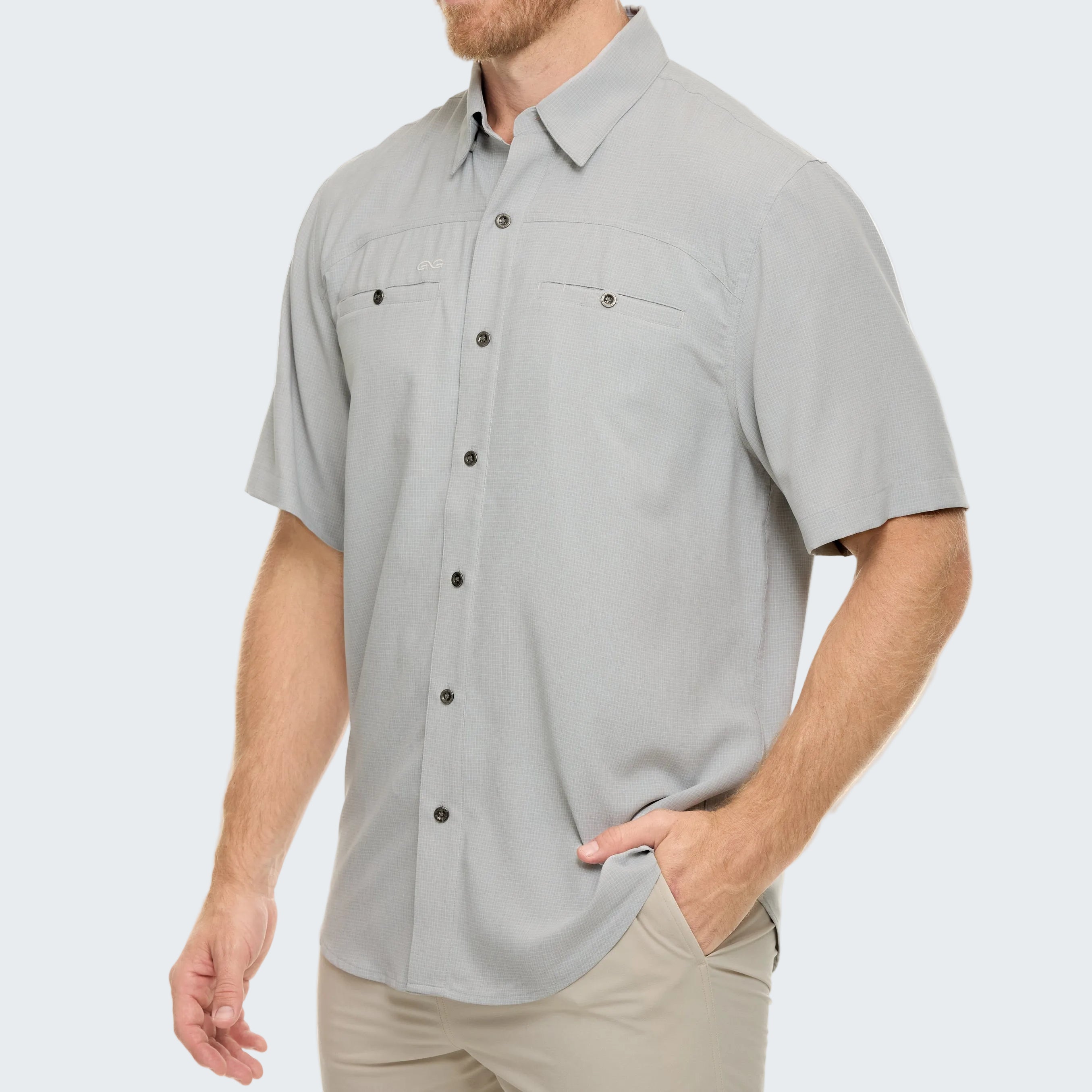 Man wearing a gray short-sleeve button-up shirt on a white background