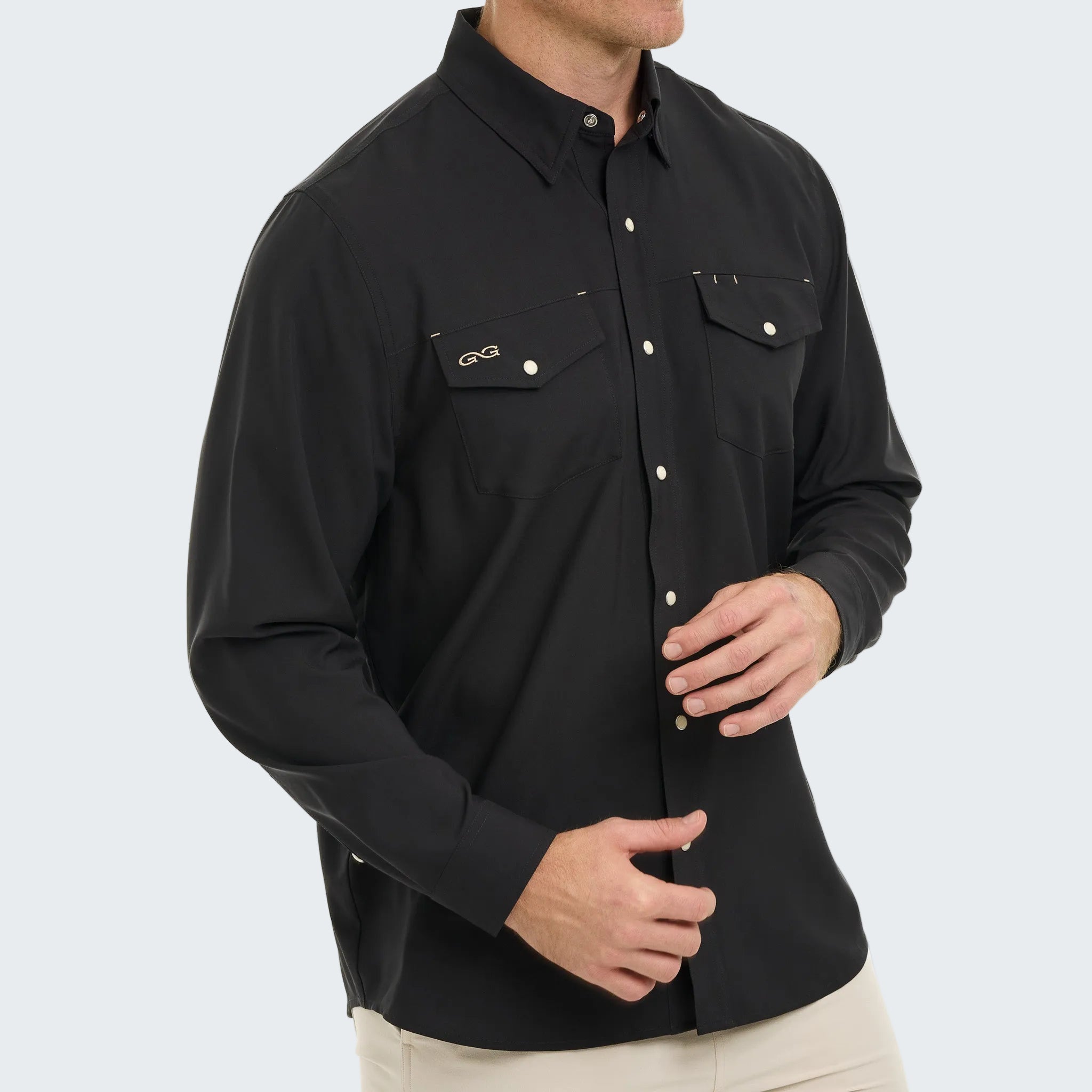 Black long-sleeve shirt with button details on a white background