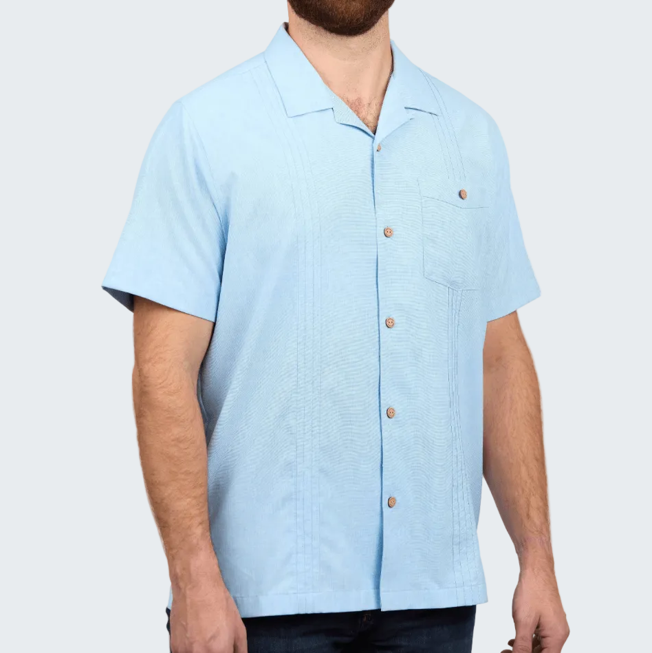 Light blue short-sleeve shirt worn by a person on a white background