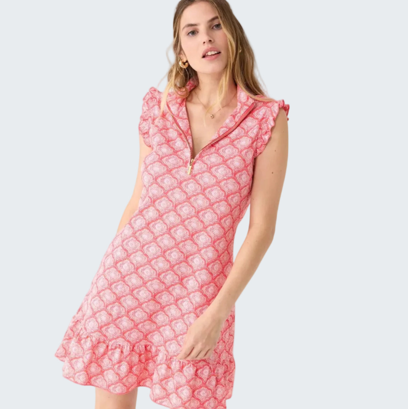 Woman wearing a pink patterned dress on a white background