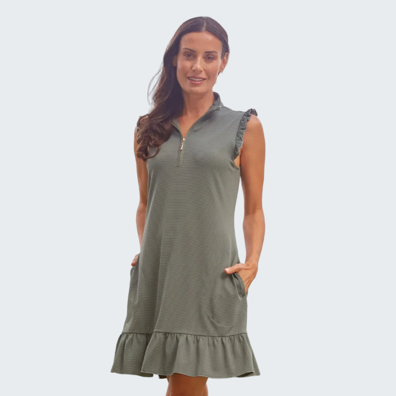 Woman wearing a green dress with a zipper on a beach