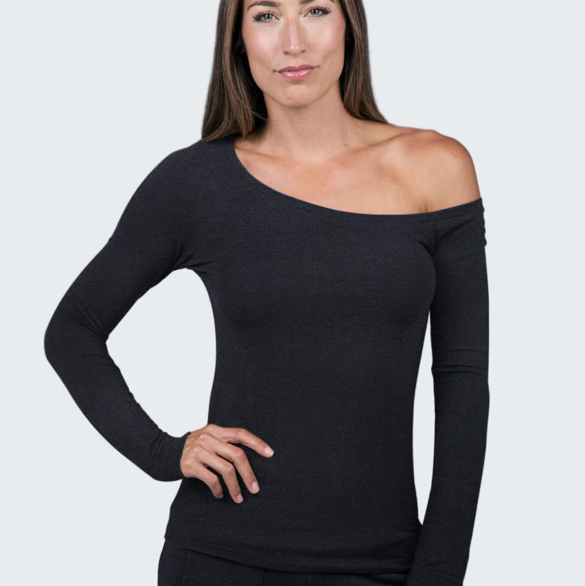 Woman wearing a black off-shoulder top against a gray background