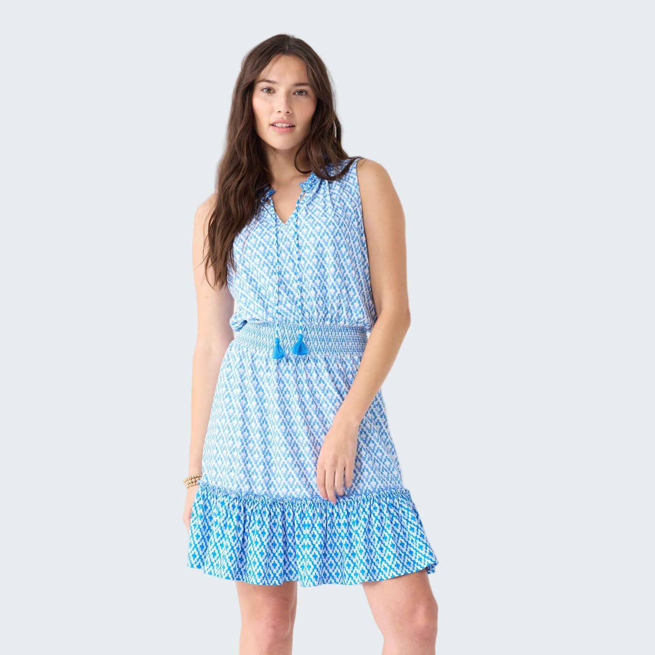 Woman wearing a blue patterned dress on a white background