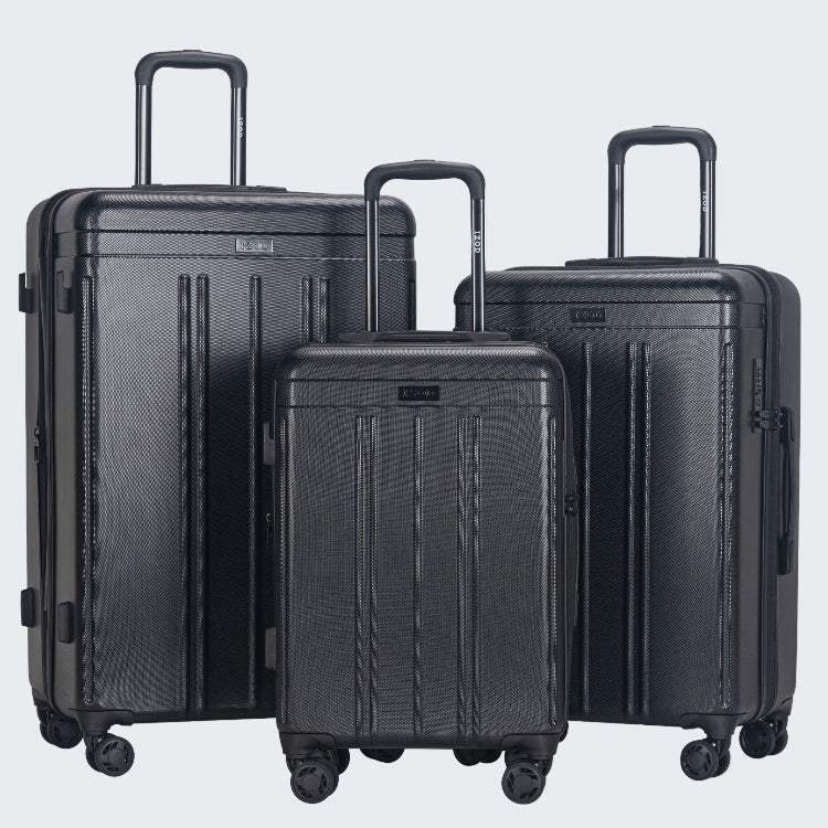 Set of three black suitcases of different sizes on a white background