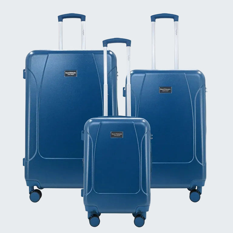 Set of three blue suitcases with wheels on a white background