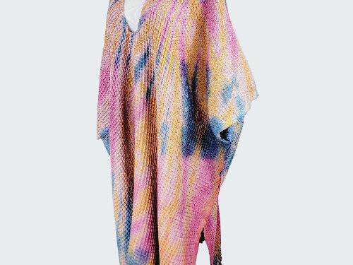 Colorful patterned scarf on a mannequin against a white background
