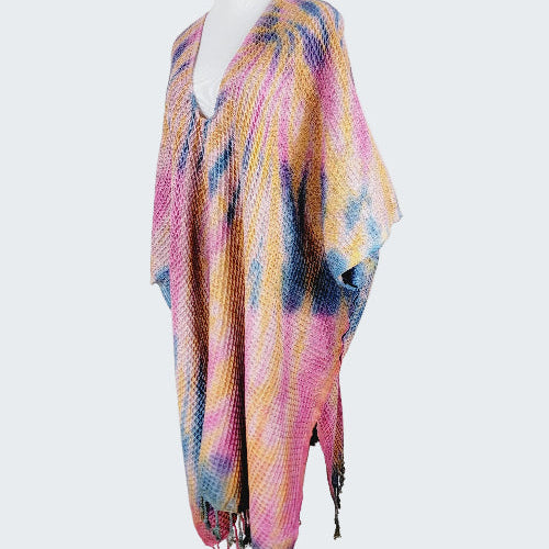 Colorful patterned scarf on a mannequin against a white background