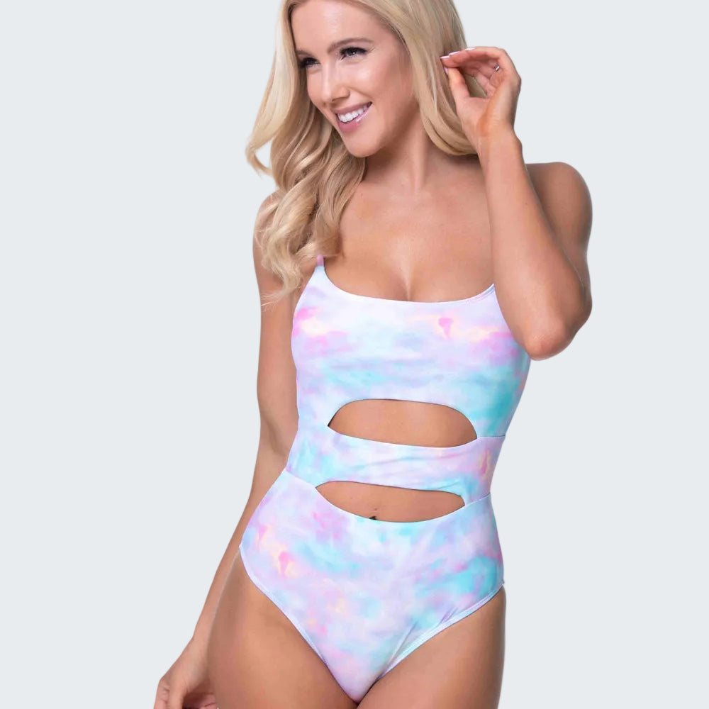 Woman wearing a colorful one-piece swimsuit on a white background