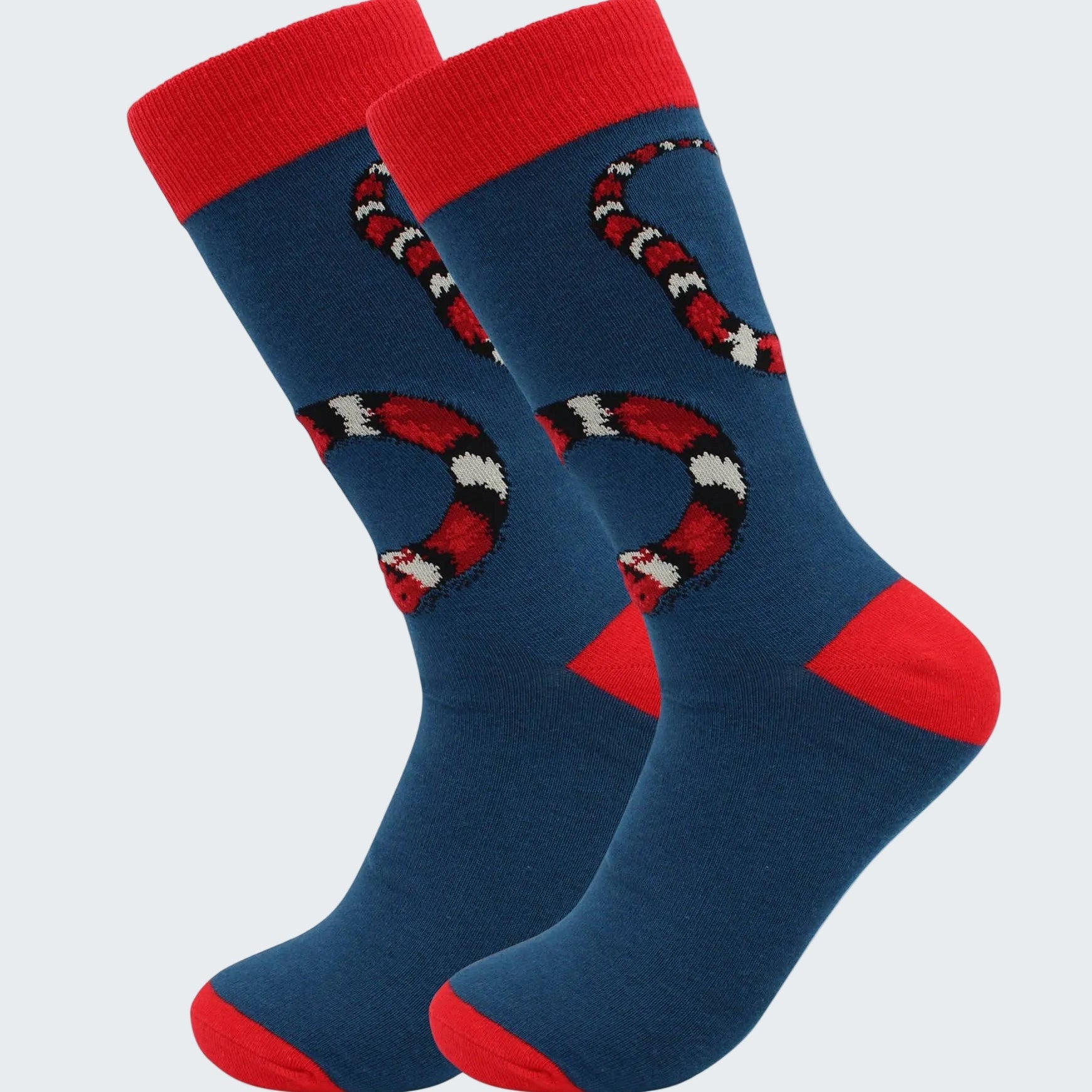 Pair of blue socks with red accents and snake design on a white background