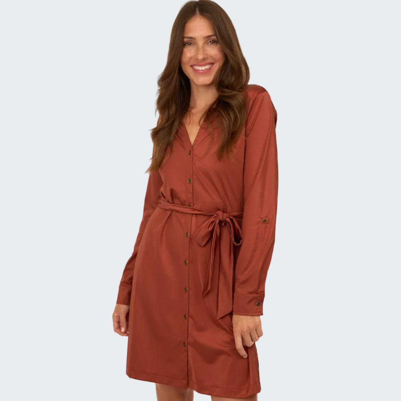 Woman wearing a brown dress with a belt on a white background