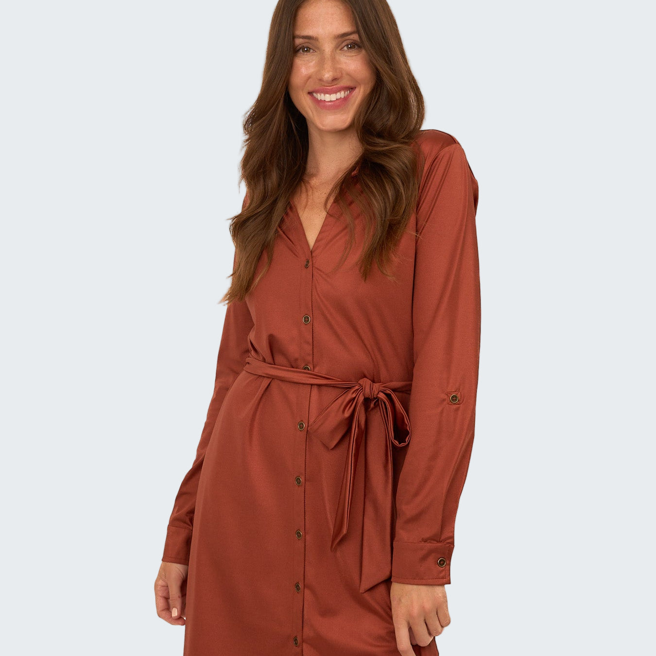 Woman wearing a brown dress with a belt on a white background