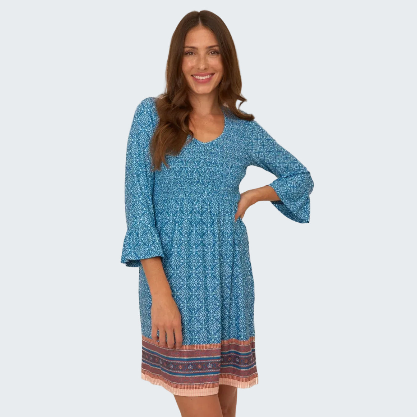 Woman wearing a blue patterned dress on a white background