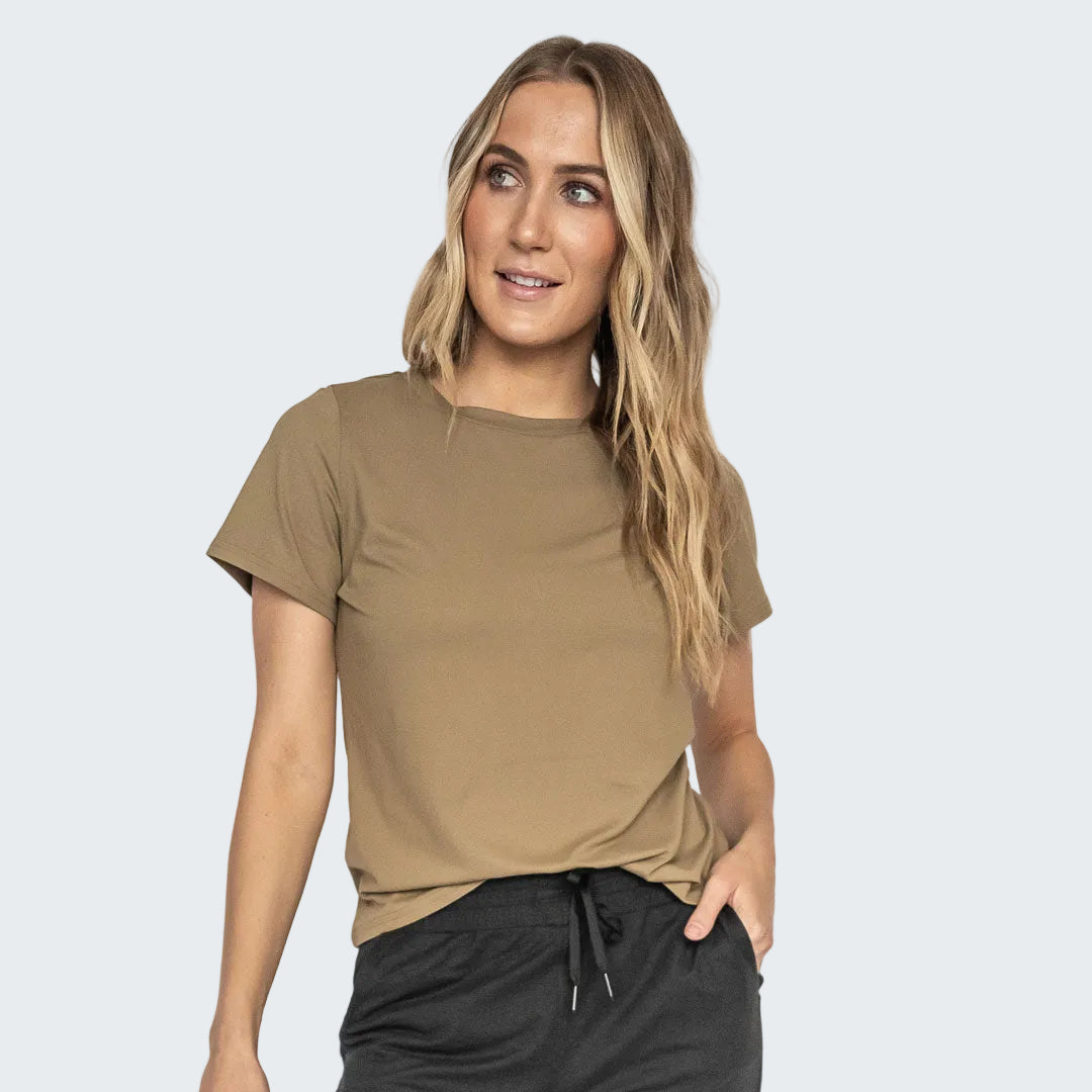 Woman wearing a brown t-shirt and black pants on a white background