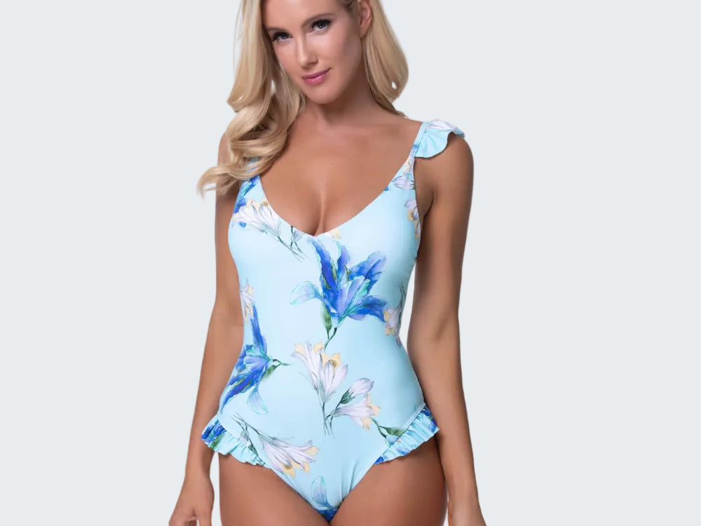 Woman wearing a blue floral one-piece swimsuit on a white background