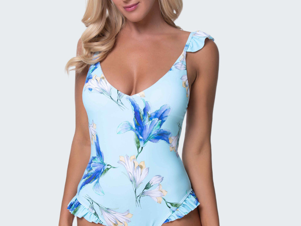 Woman wearing a blue floral one-piece swimsuit on a white background