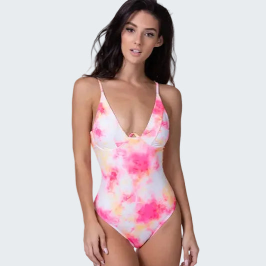Woman wearing a colorful tie-dye swimsuit on a white background