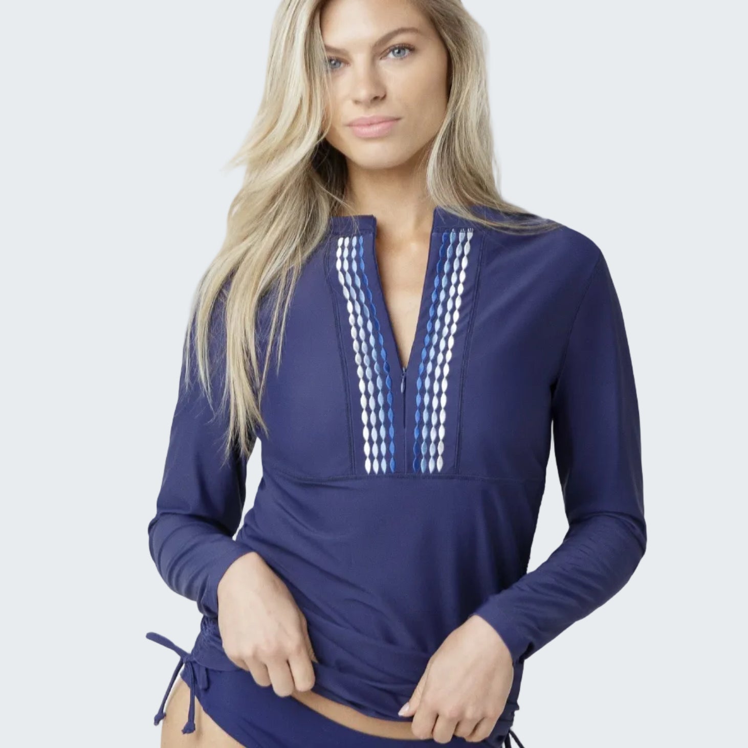 Woman wearing a blue swimsuit with long sleeves on a white background
