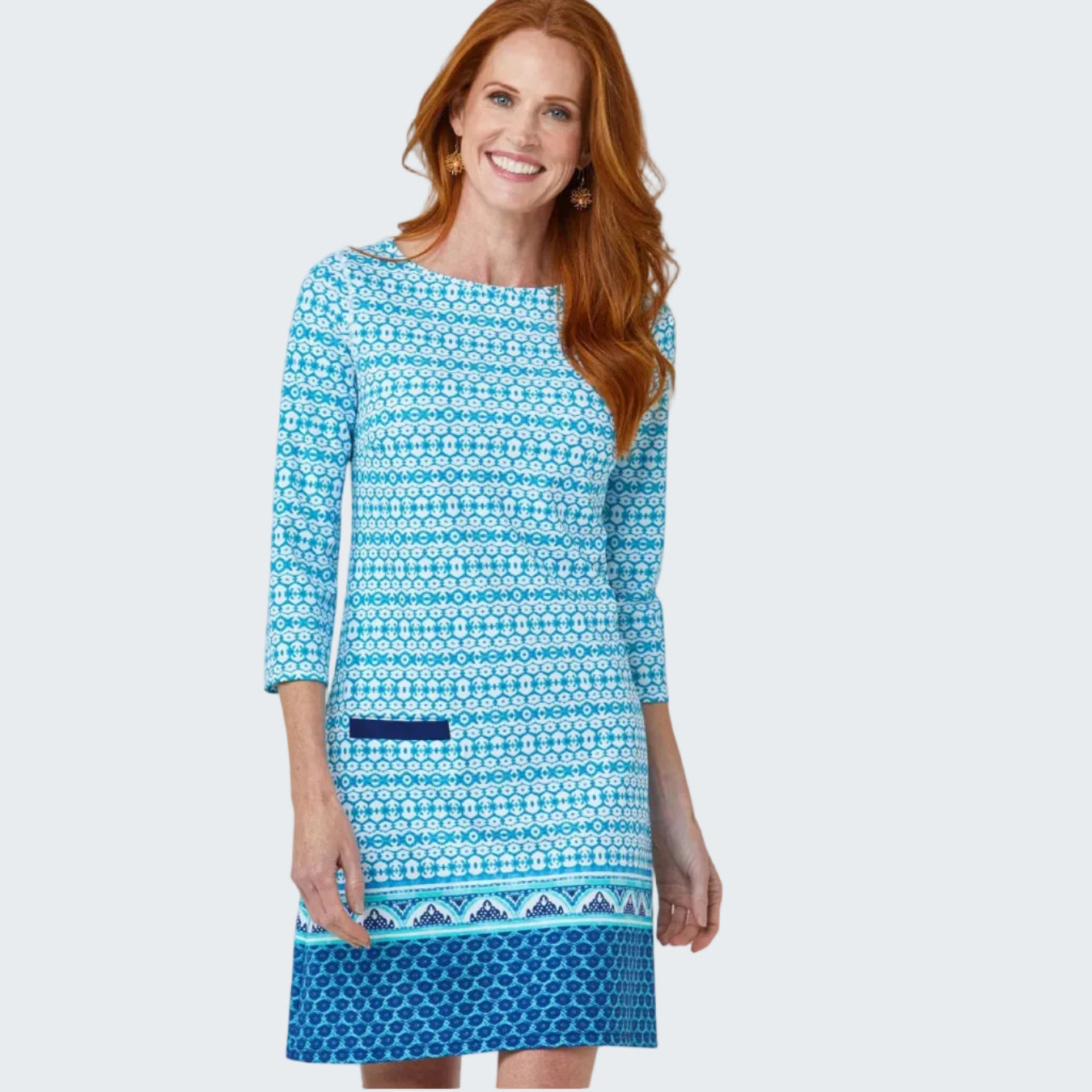 Woman wearing a blue patterned dress on a white background