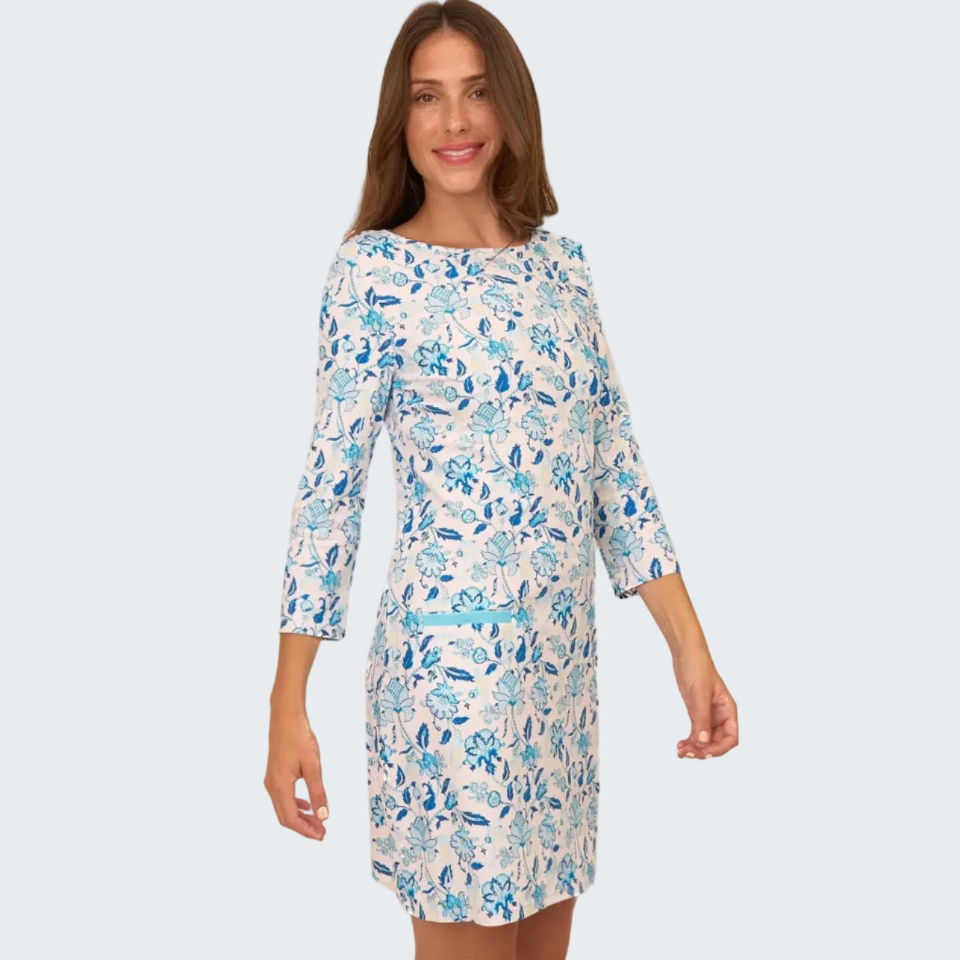 Woman wearing a floral dress with blue flowers on a white background