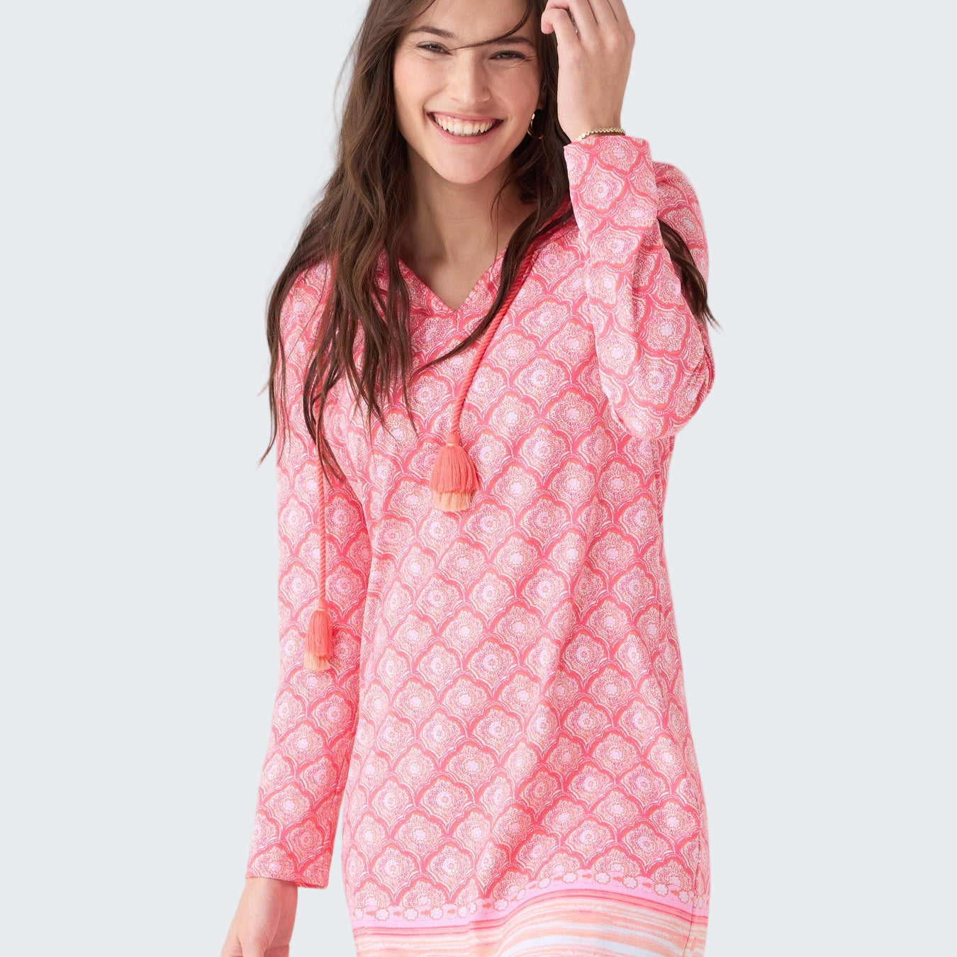 Woman wearing a pink quilted dress with a white background