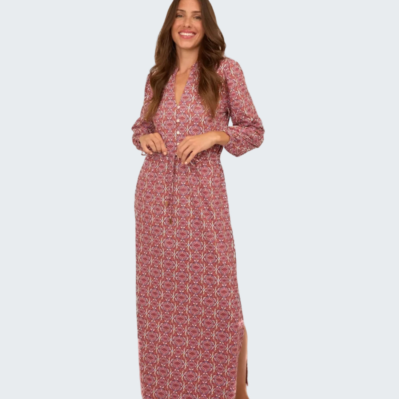 Woman wearing a red patterned dress on a white background