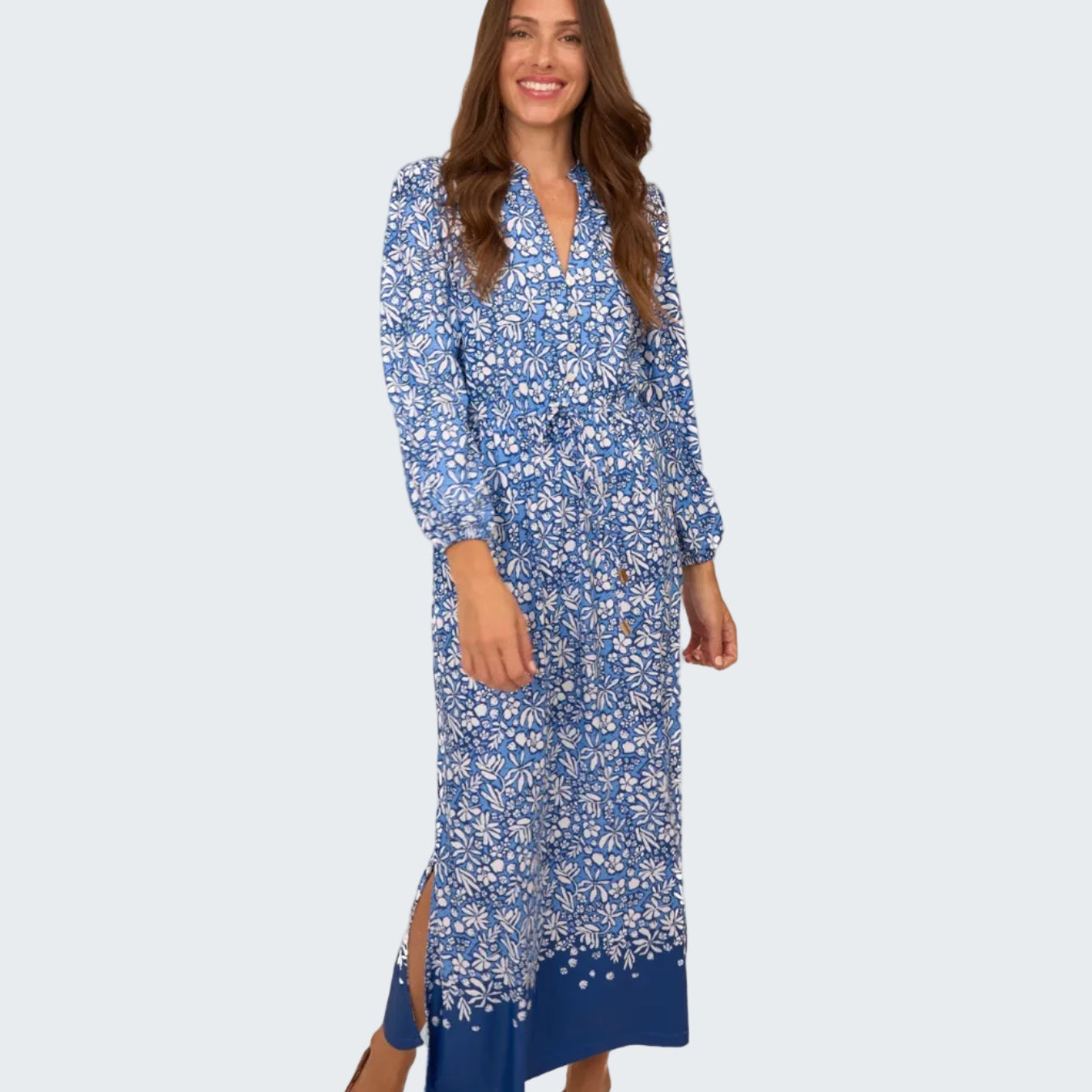 Woman wearing a blue floral dress on a white background