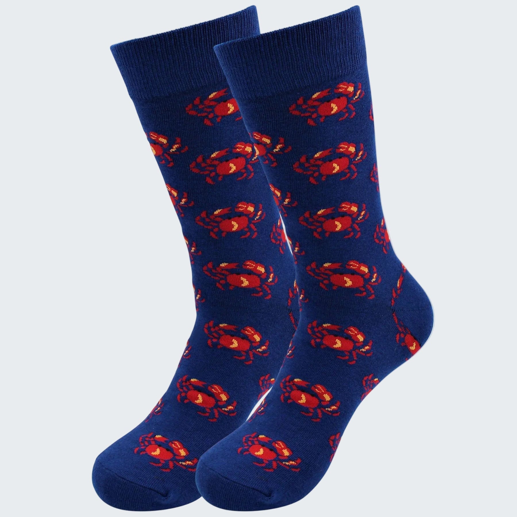 Pair of blue socks with red crab pattern on a white background