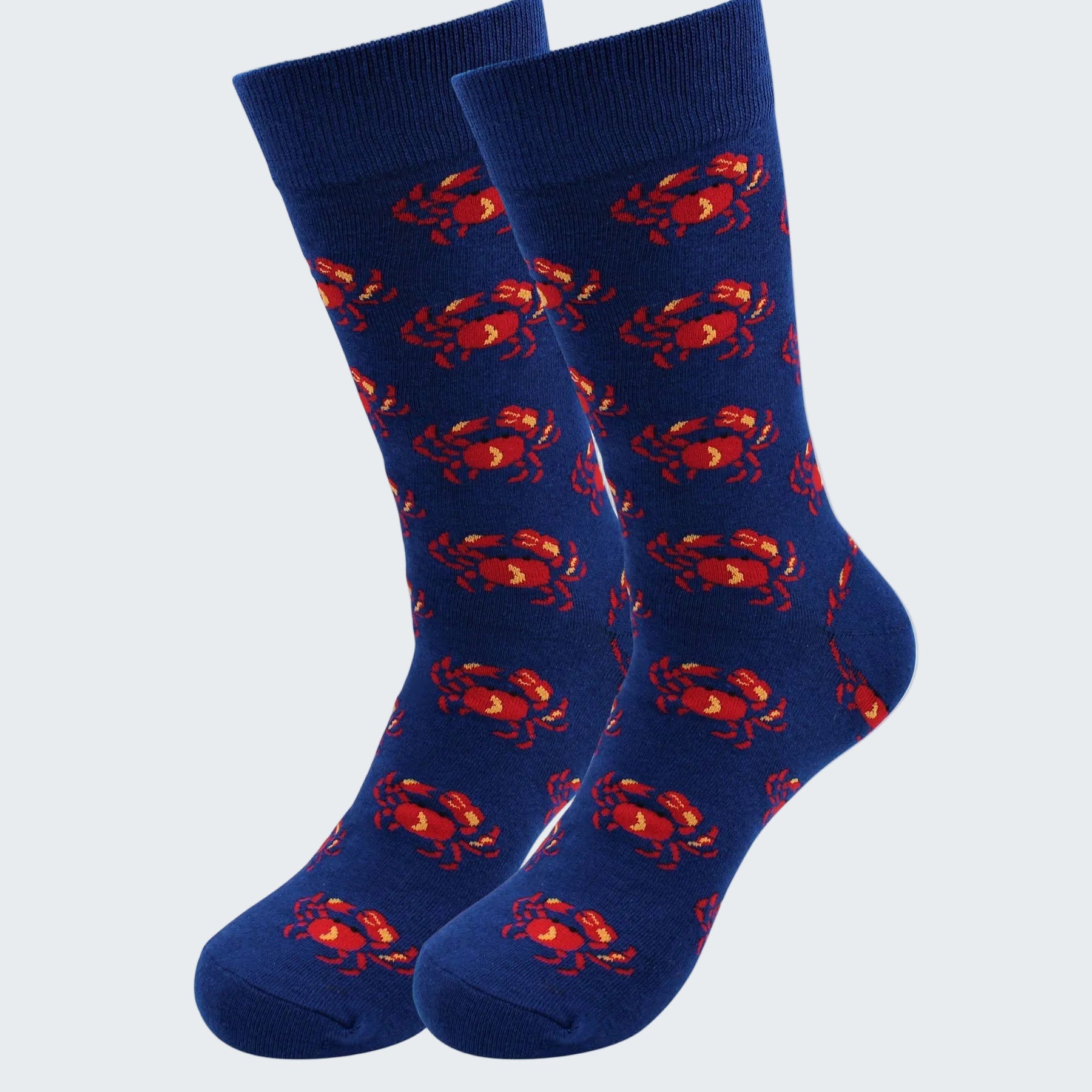 Pair of blue socks with red crab pattern on a white background