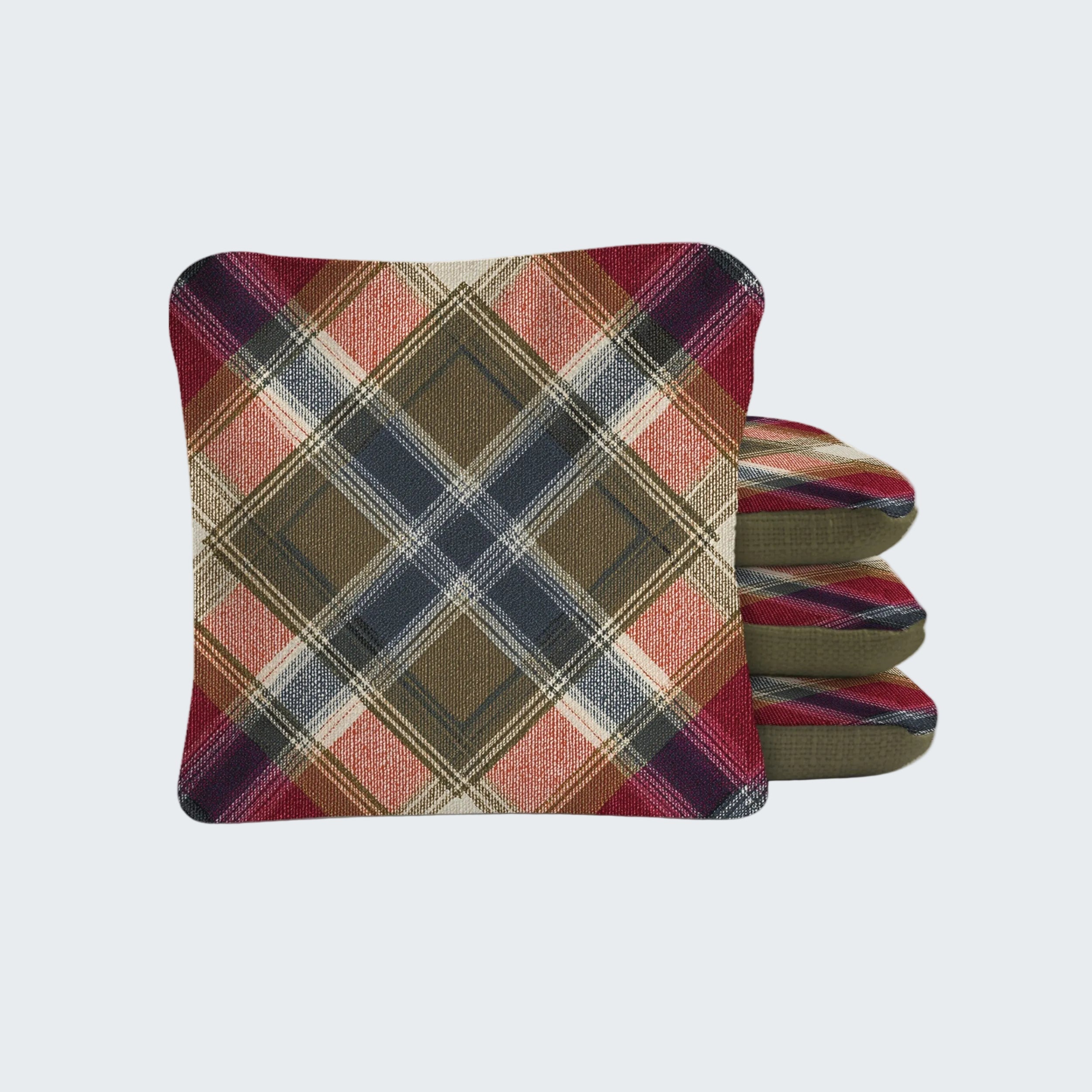 Stack of plaid fabric cushions on a white background