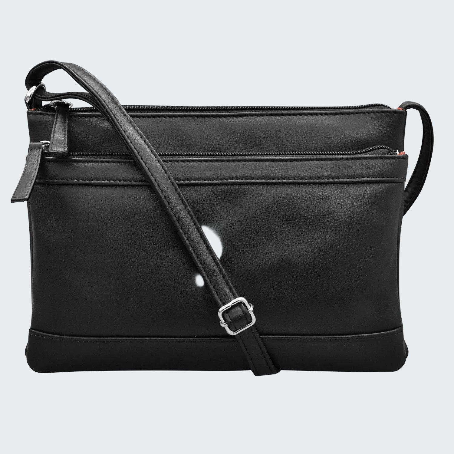 Black faux-leather crossbody bag with a top zipper, front slip pocket, and adjustable shoulder strap with a silver buckle, shown on a plain white background.