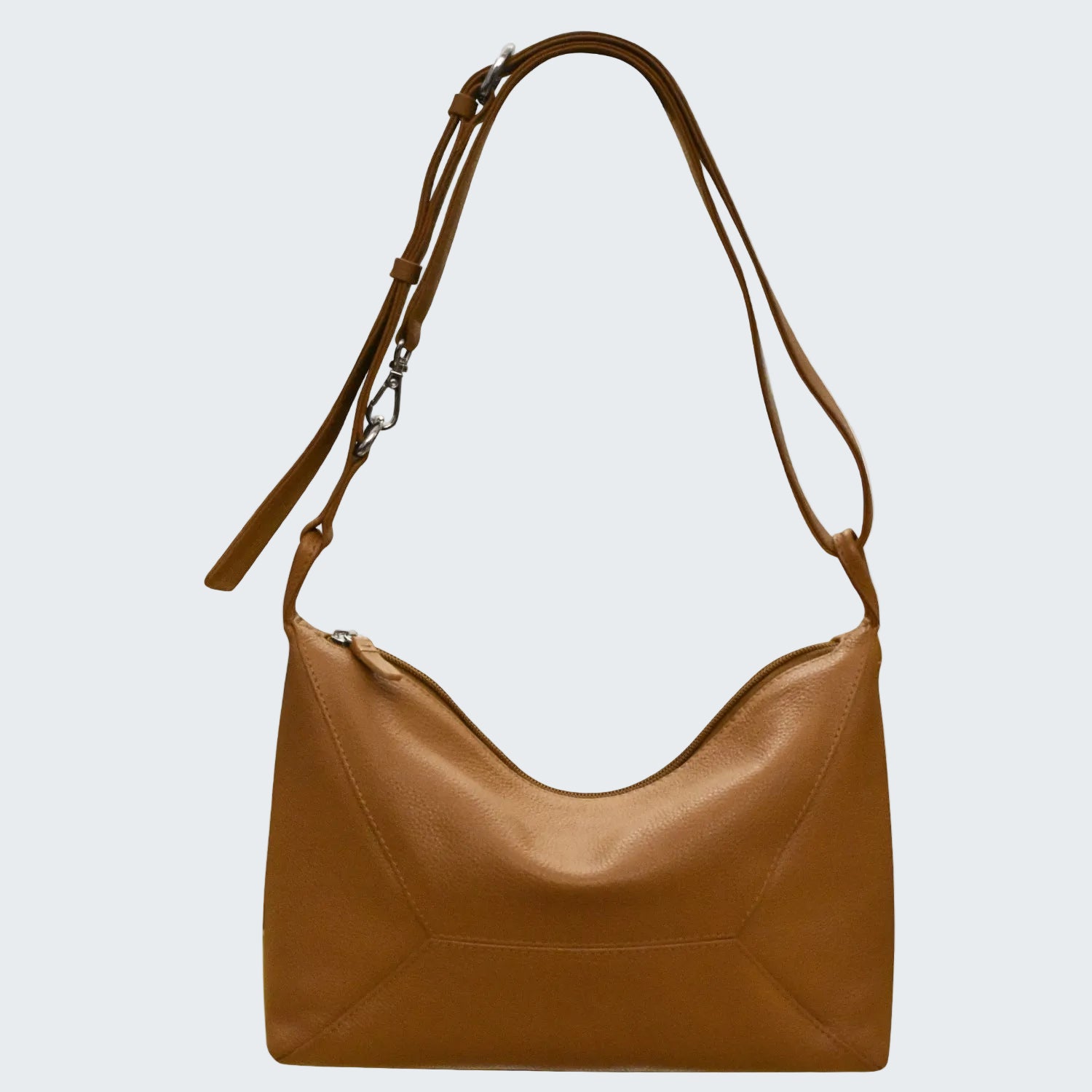 Brown leather handbag with a shoulder strap on a white background