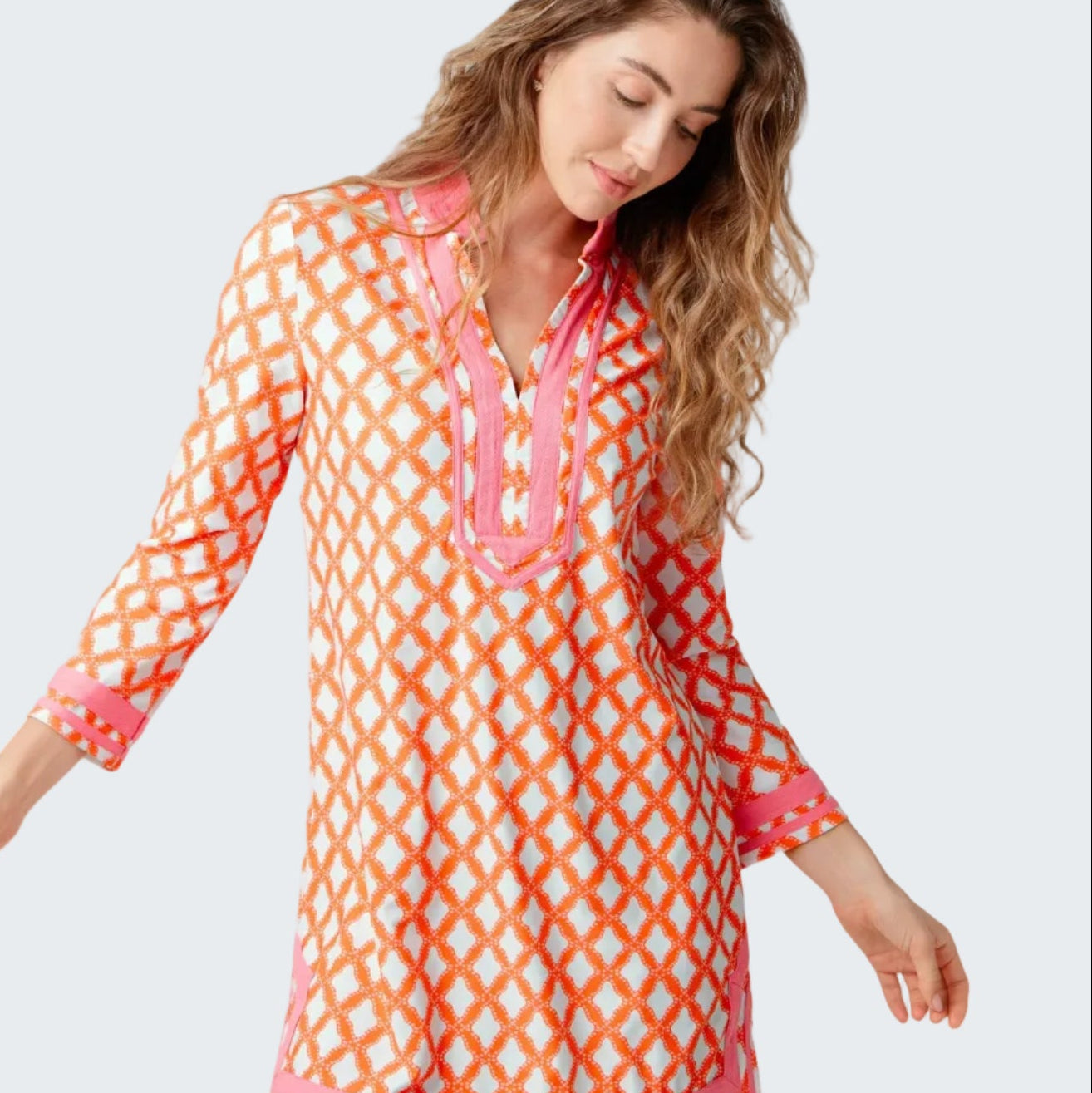 Woman wearing a colorful patterned dress on a white background