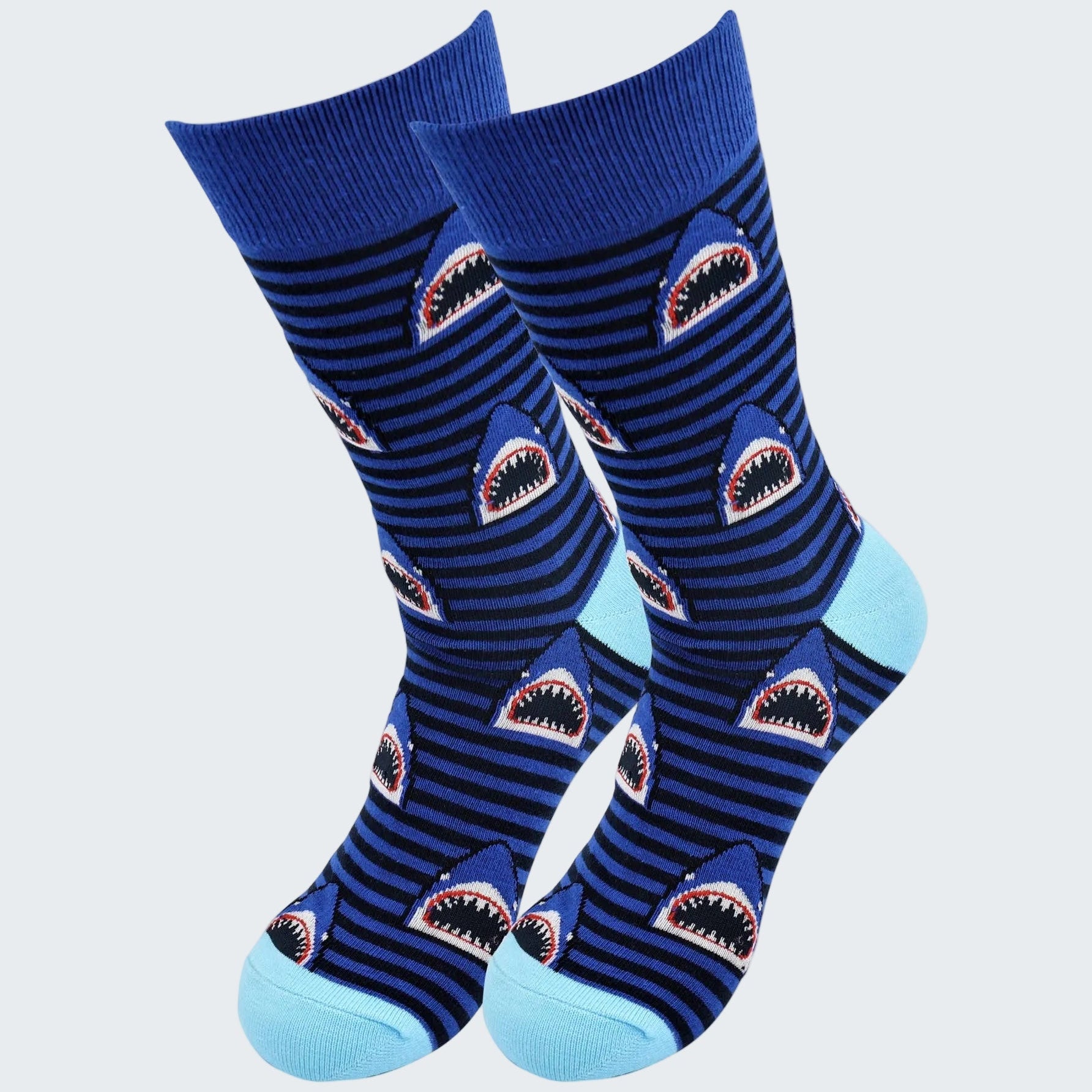 Pair of blue socks with shark design on a white background