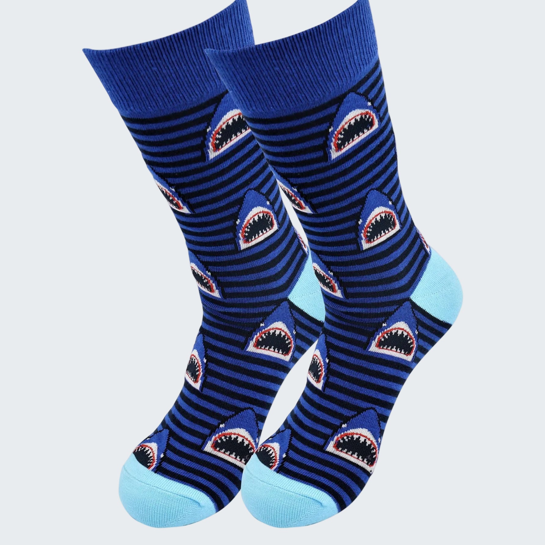 Pair of blue socks with shark design on a white background