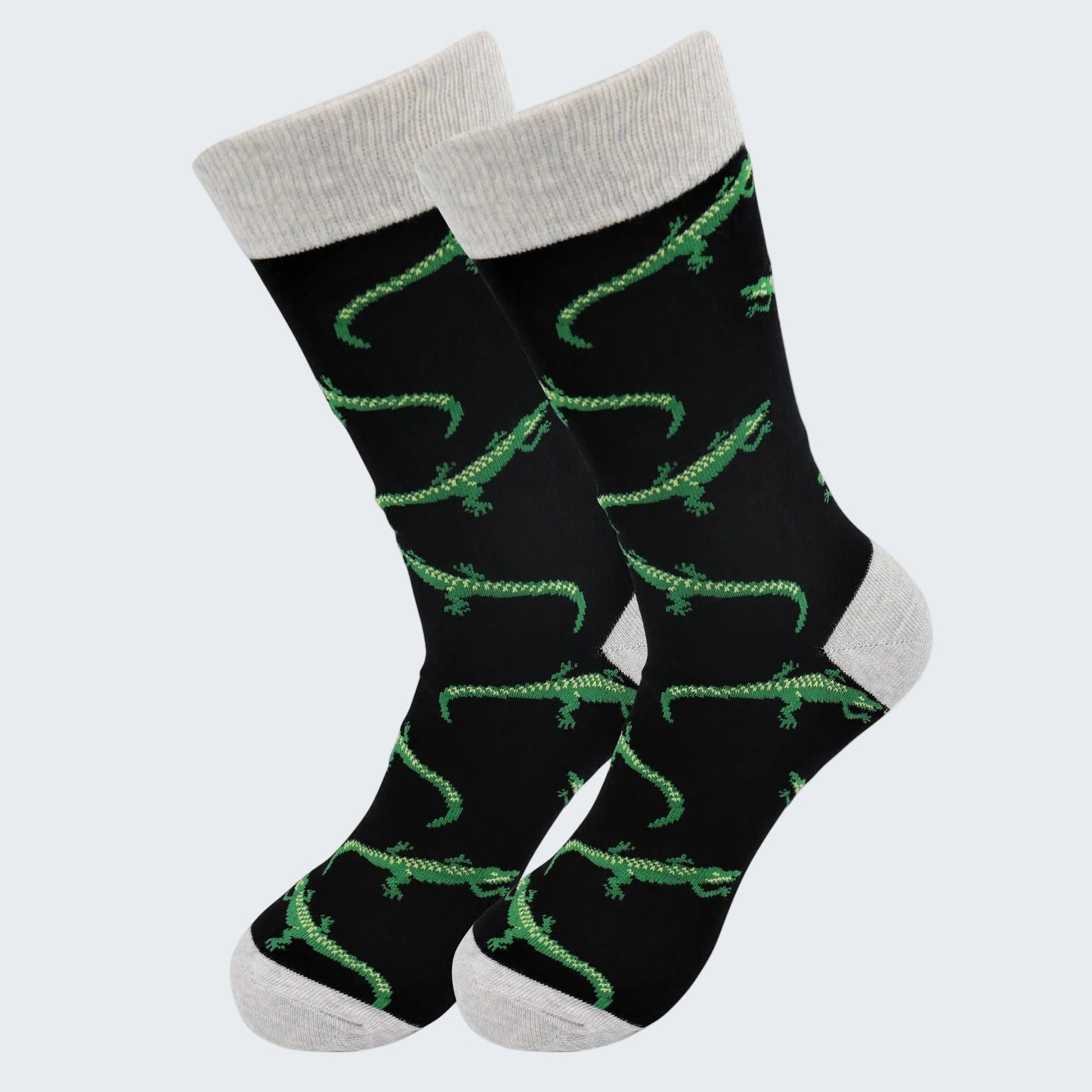 Black socks with green alligator pattern and gray cuffs and toes on a white background