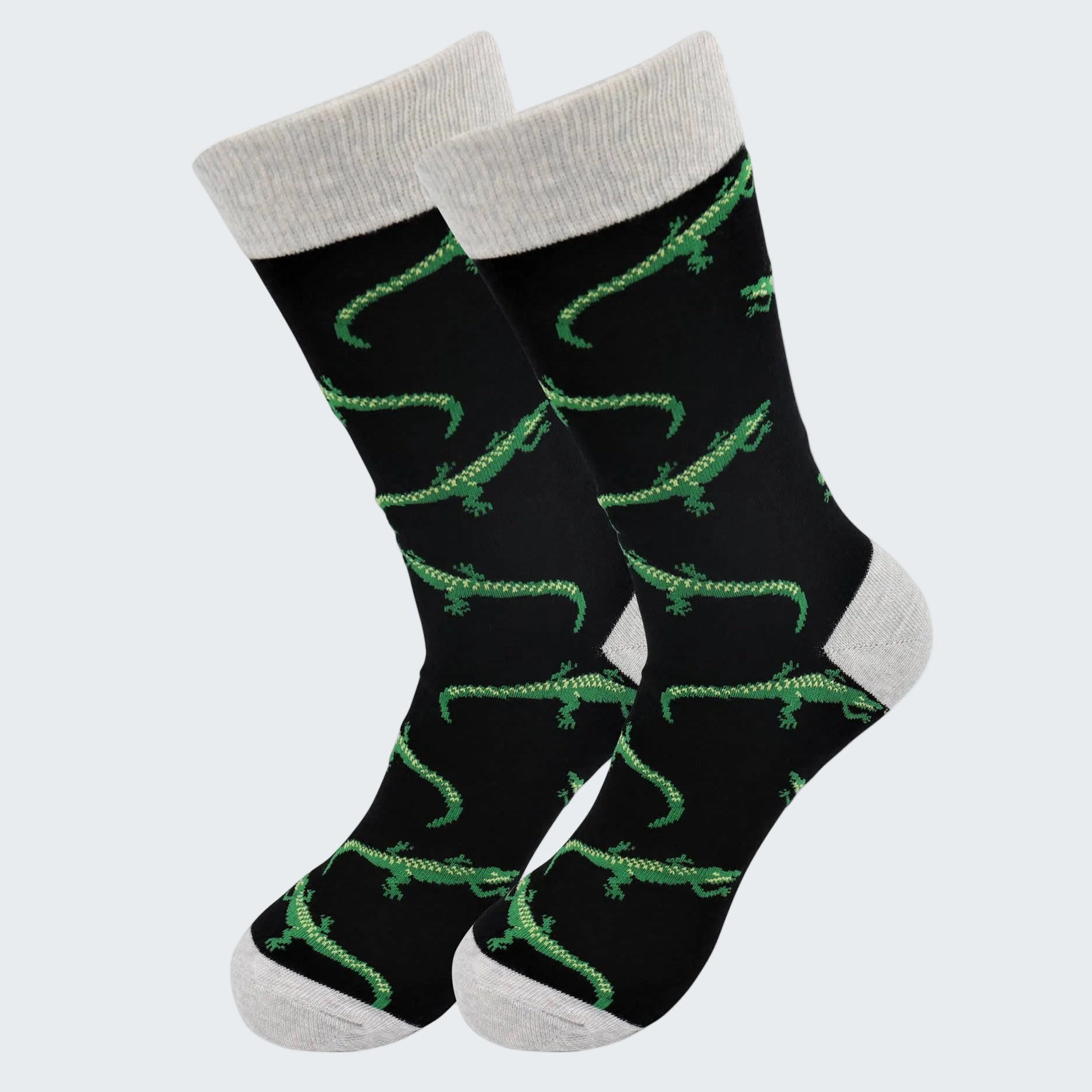 Black socks with green alligator pattern and gray cuffs and toes on a white background