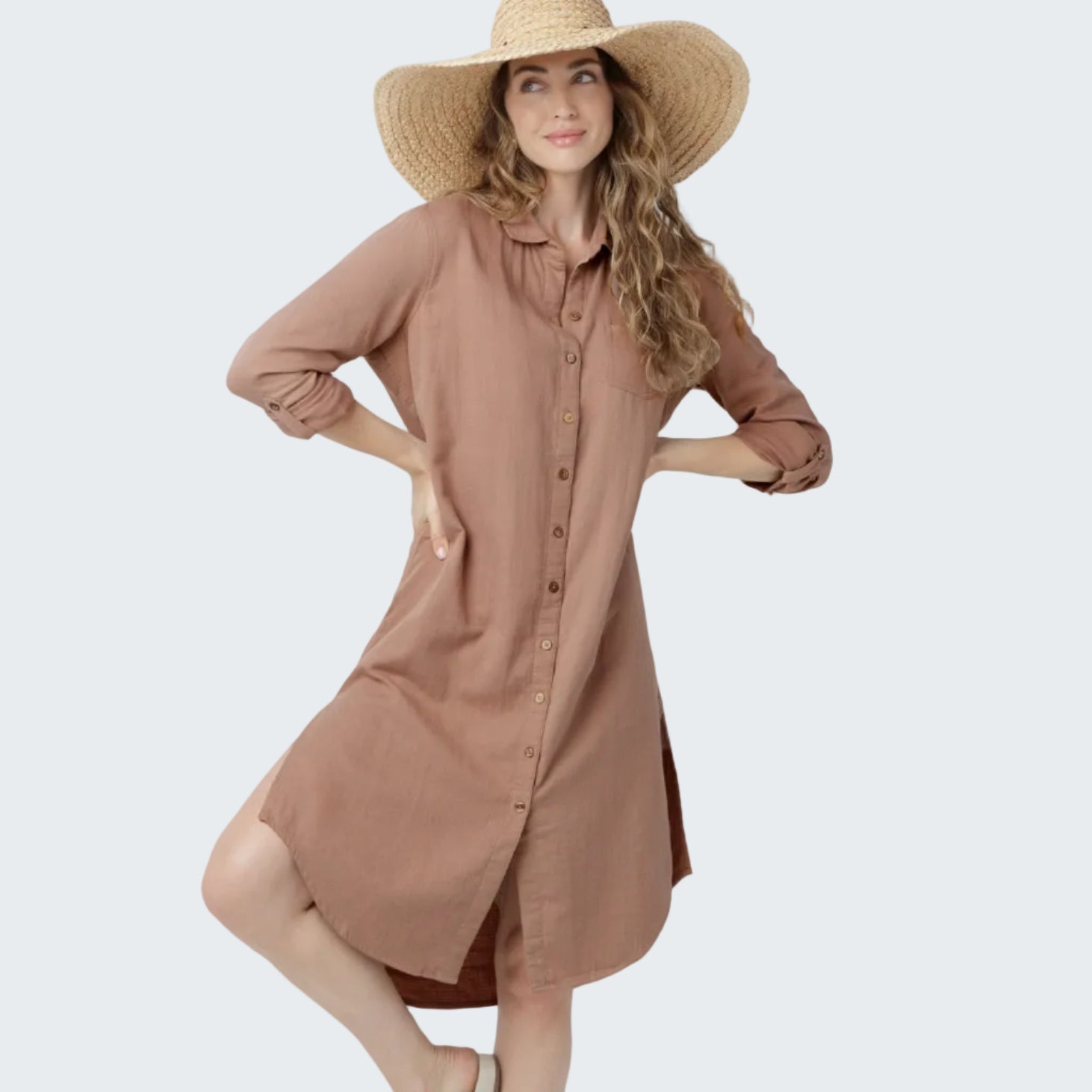 Woman wearing a brown dress and wide-brimmed hat on a white background