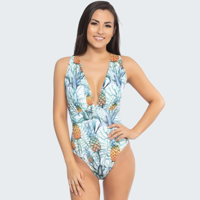 Woman wearing a tropical print swimsuit on a white background