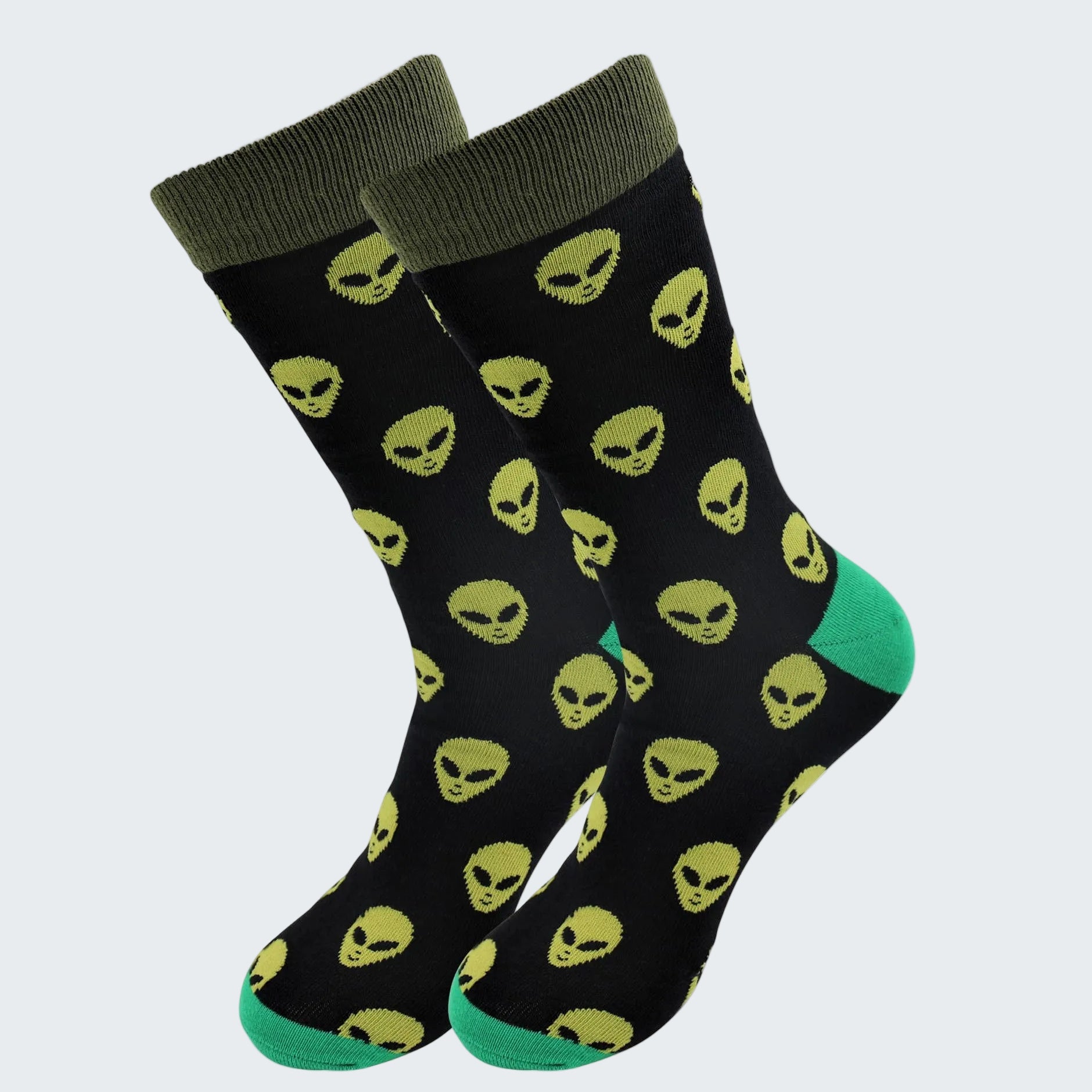 Black socks with yellow alien pattern and green accents on a white background