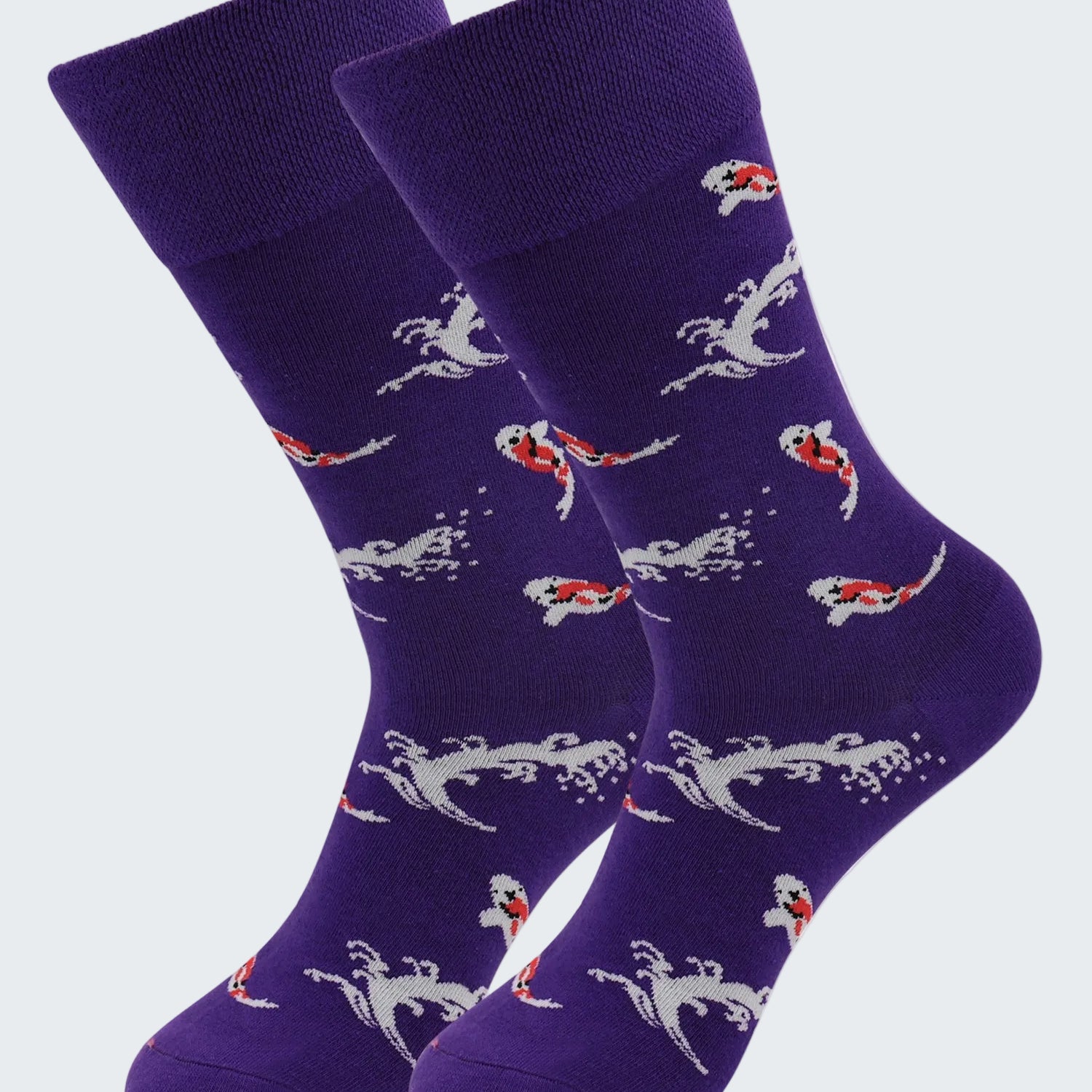 Purple socks with mermaid pattern on a white background