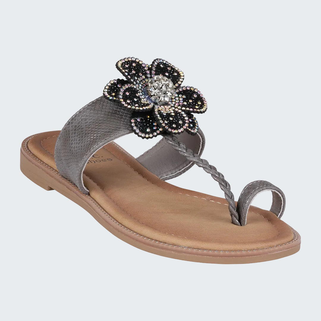 Silver sandal with a decorative flower on a white background